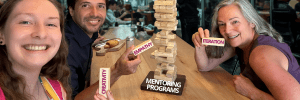 3 people playing a jenga game with iteration creativity and empathy written on the pieces