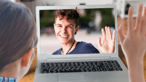 a person waving to another person on a zoom call