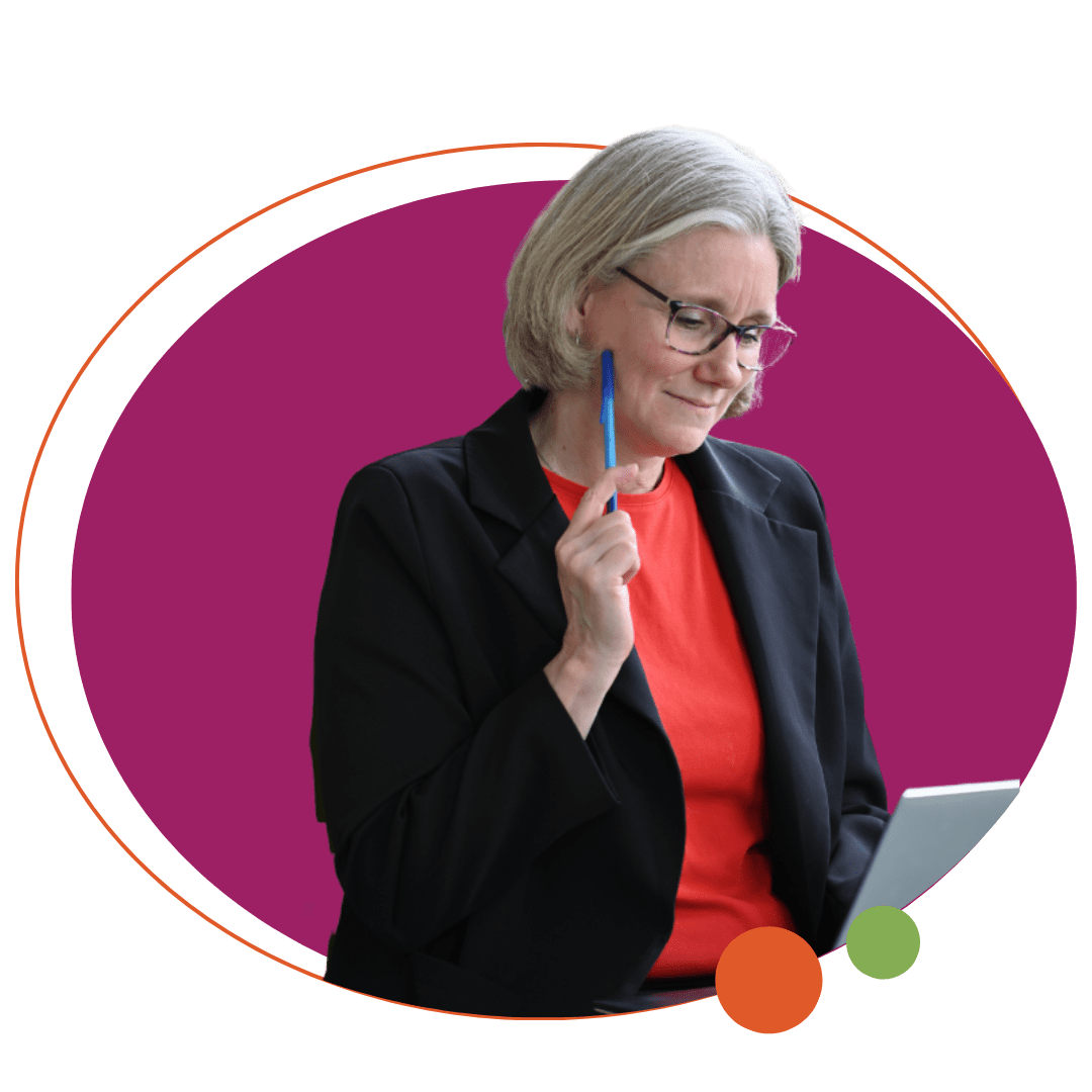 a woman sitting thinking looking at a laptop