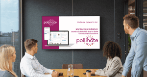a group of people sitting around a board room table watching a presentation