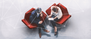 view from above of 2 people sitting on red chairs with a network graphic overlayed