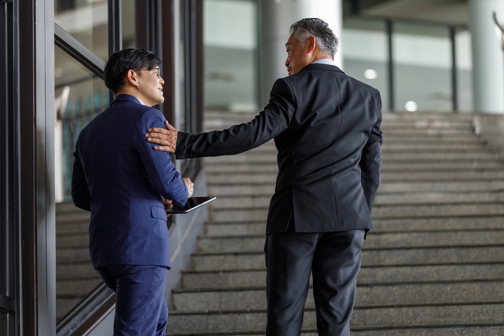 Two professionals discussing member engagement strategies during a one-on-one mentoring conversation
