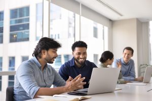 Two professionals in a mentor matching conversation at an office table