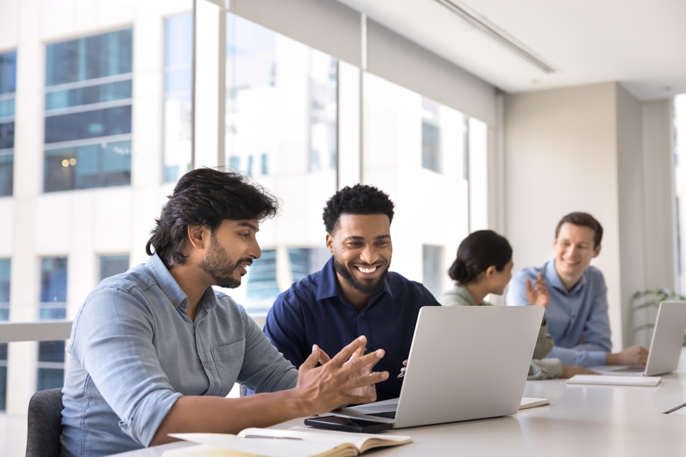 Two professionals in a mentor matching conversation at an office table