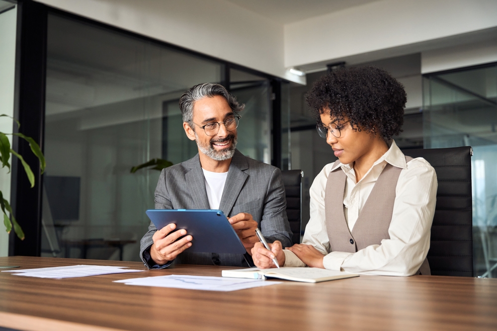Two professionals talking after connecting through a mentoring program