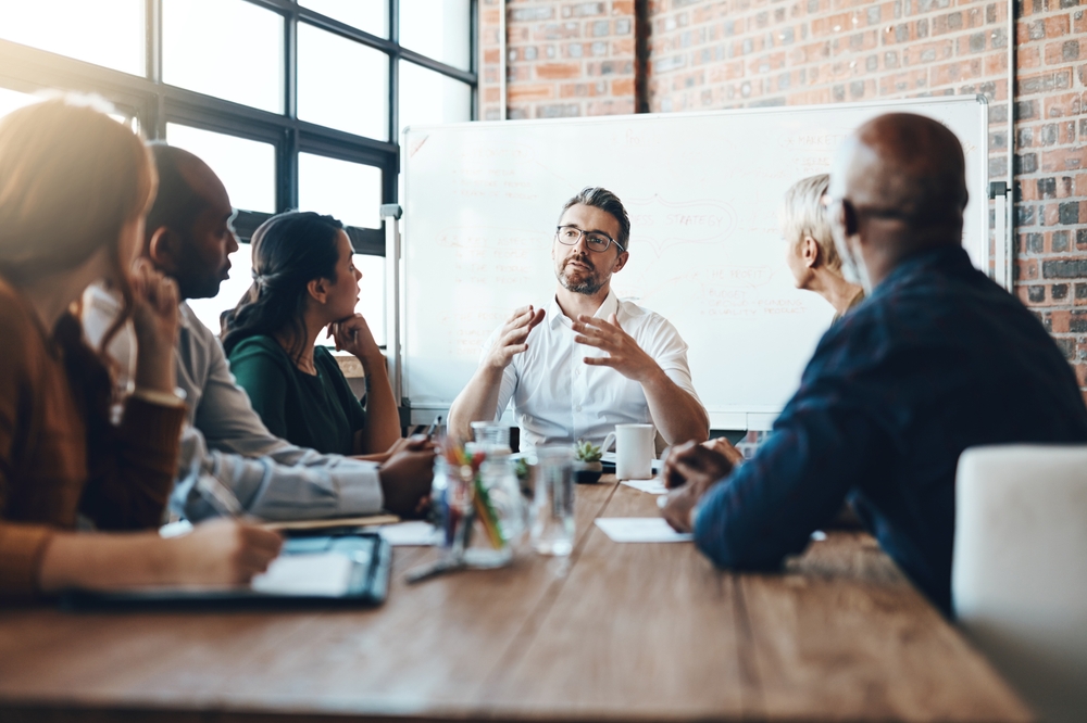 Diverse colleagues networking at a corporate mentoring program launch event