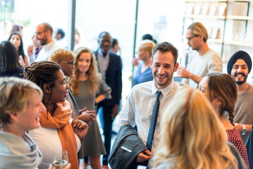 Group of professionals in conversation about talent development strategies during a peer mentoring session
